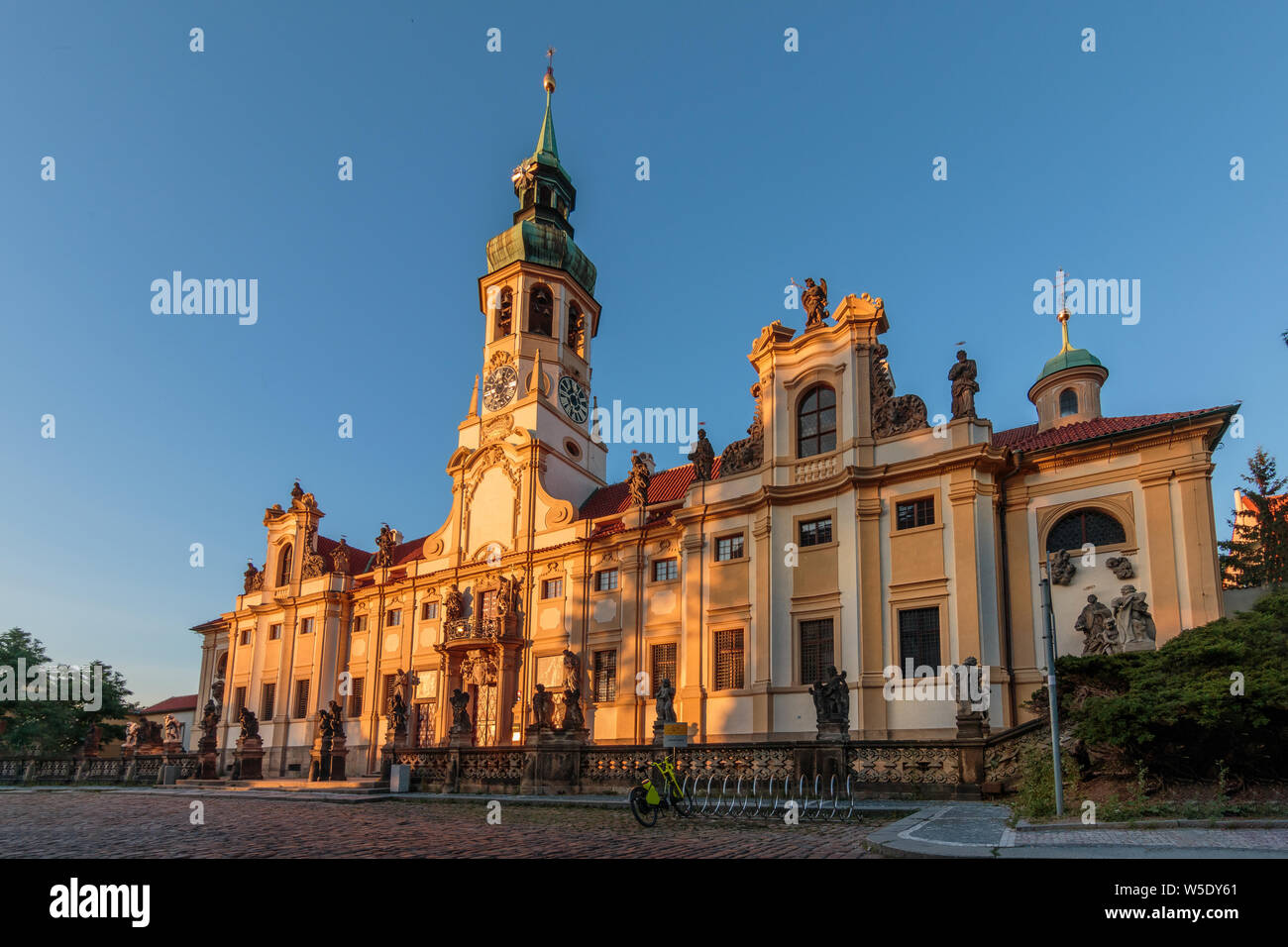 Historical Capuchin Church Loreta from Hradcany Square near the Prague Castle. View of the historic baroque building complex from the right in the eve Stock Photo