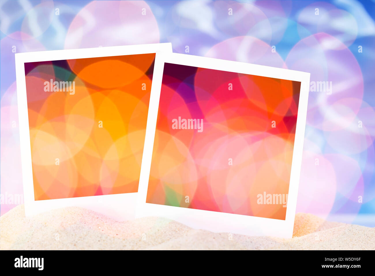 Blank instant images on sand background Stock Photo