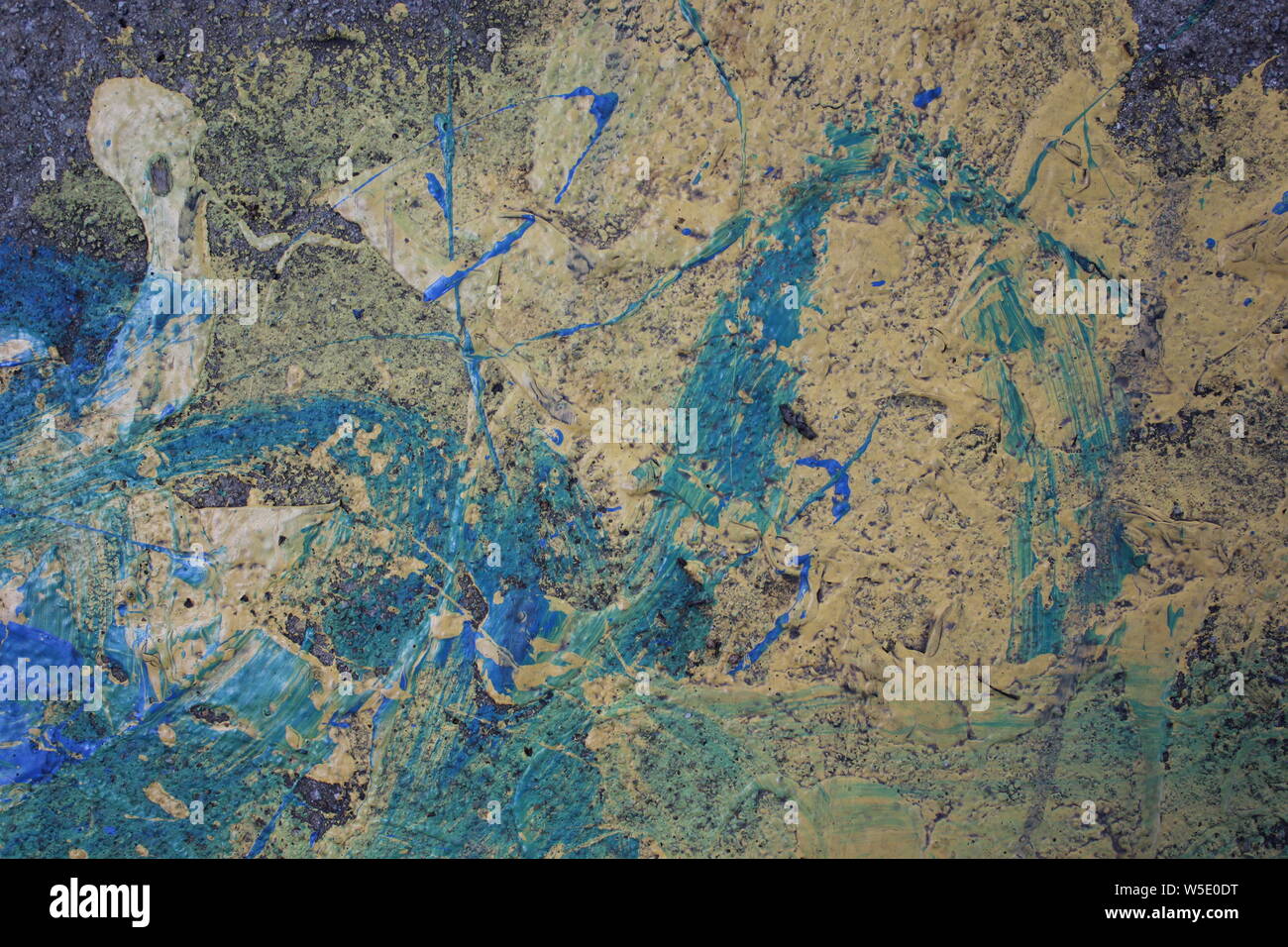 Blue and yellow paint splashed on a sidewalk Stock Photo Alamy