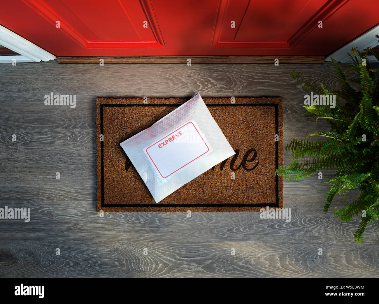 Express courier package delivered outside door. Overhead view. Copy space Stock Photo