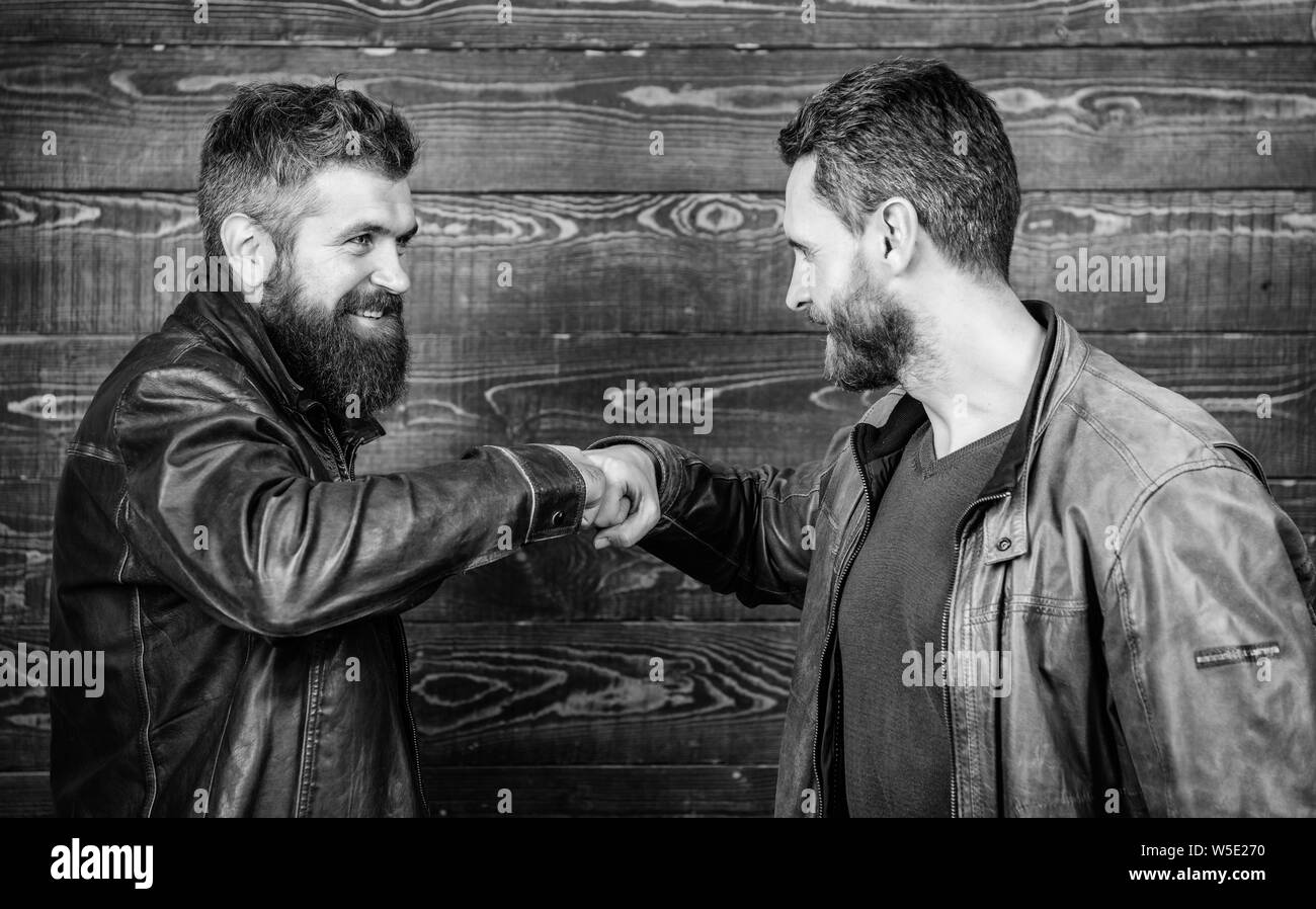 brutal-bearded-men-wear-leather-jackets-shaking-hands-strong-handshake