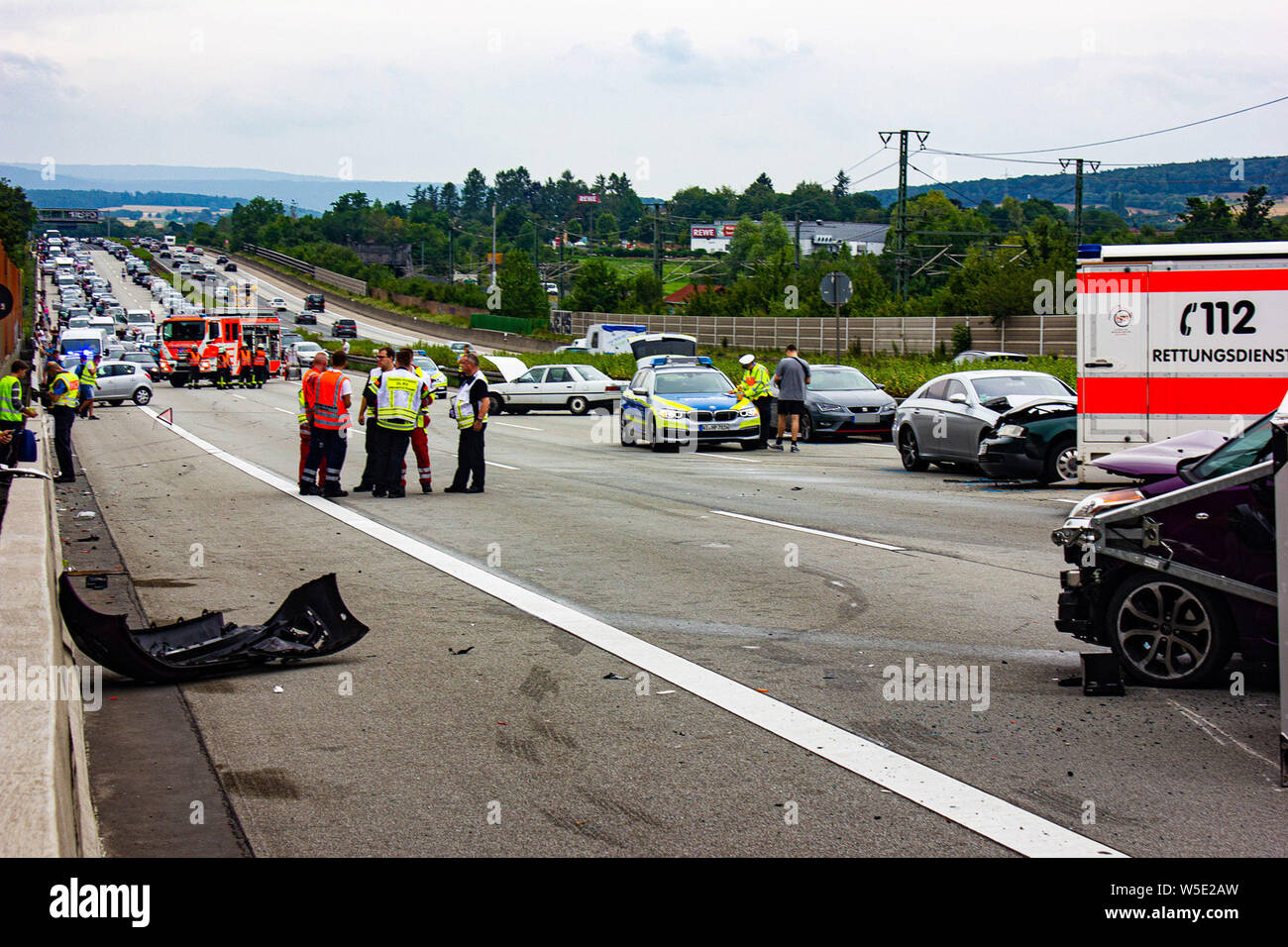 Wiesbaden, Germany. 28th July, 2019. Rescue workers are standing at an  accident site on the Autobahn 3 near Wiesbaden. An illegal race is said to  have led to a mass pile-up. According