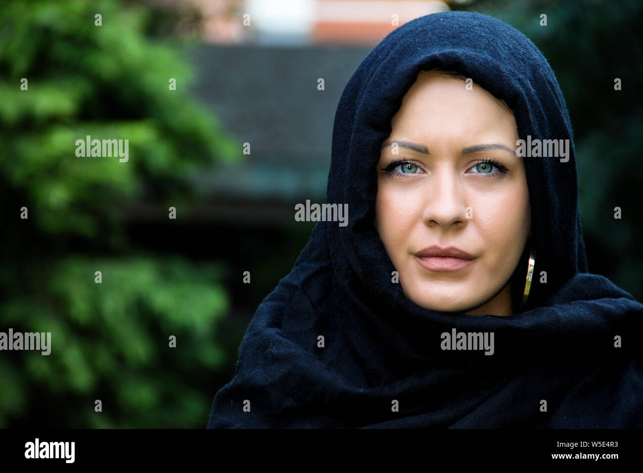 Beautiful blue eyed muslim lady posing with scarf on her head Stock Photo