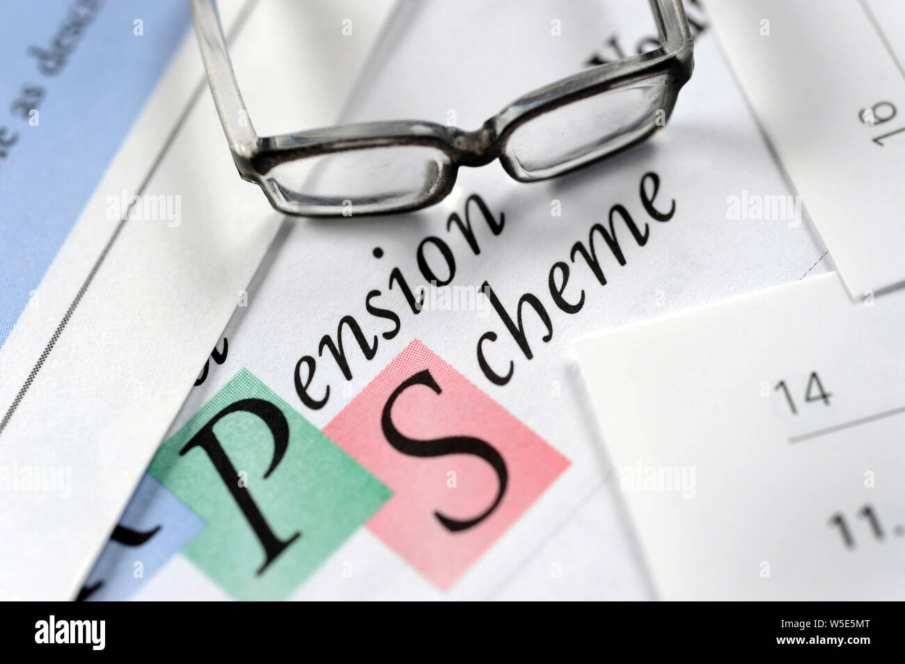 COMPANY PENSION SCHEME DOCUMENTS WITH GLASSES RE PRIVATE PENSIONS RETIREMENT INCOME SAVINGS ETC UK Stock Photo