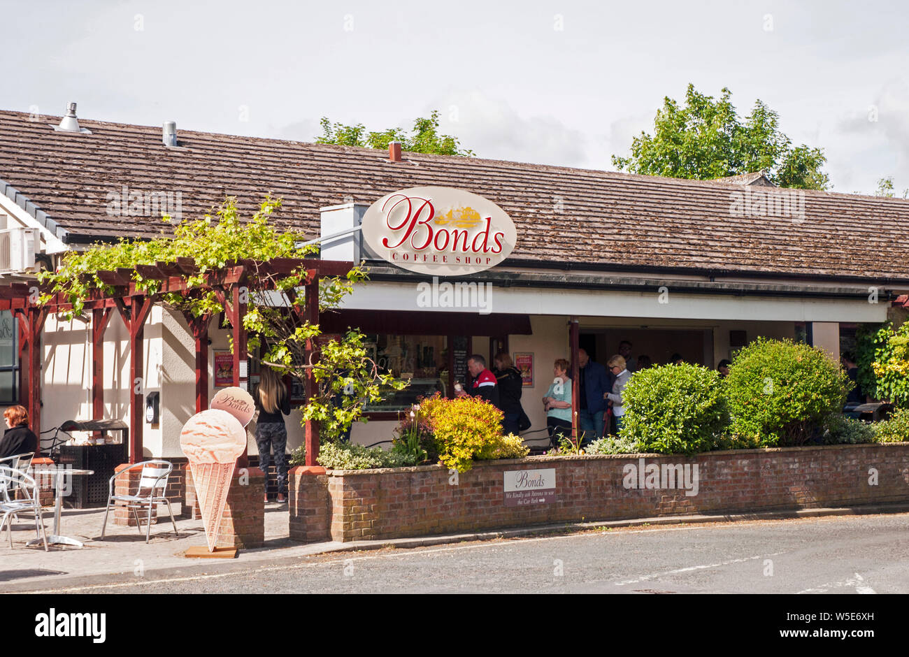 People queueing to buy ice cream at ice cream and coffee parlour in