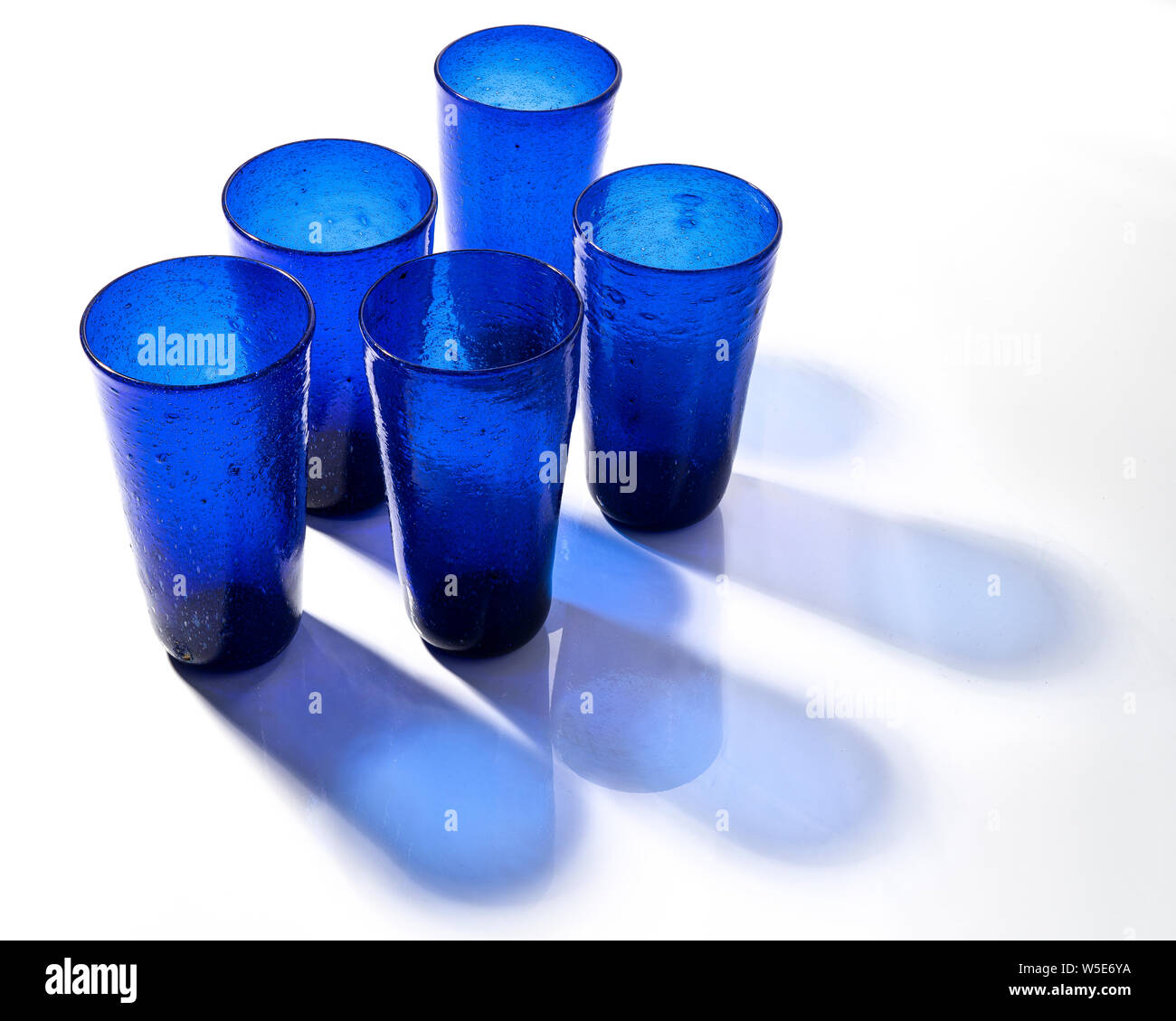 Some blue glasses on a white surface Stock Photo