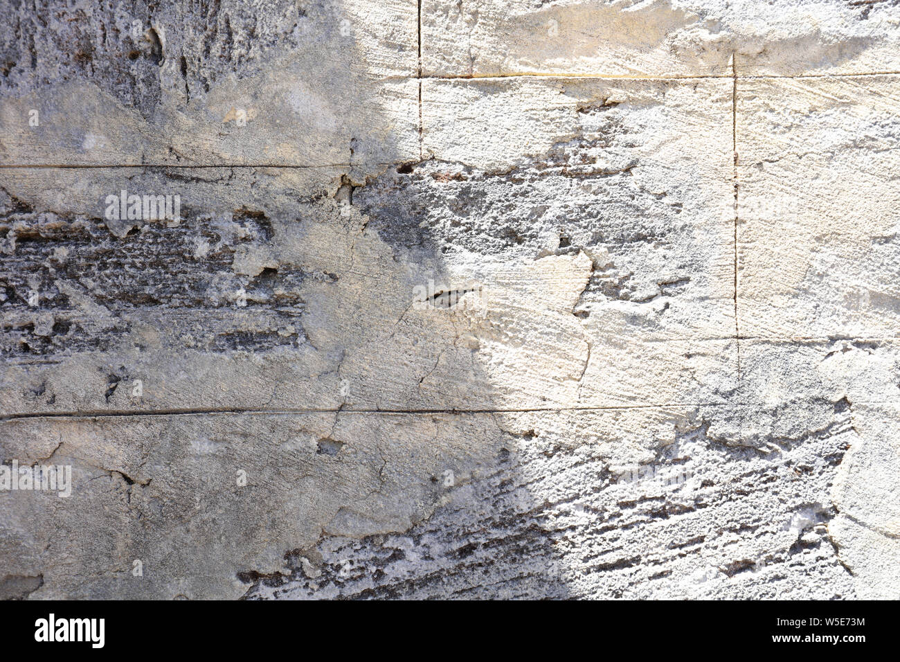 Rough texture of a concrete wall is visible after the plastered cement