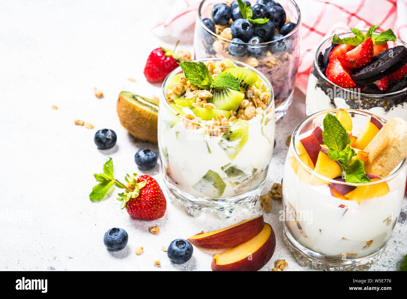 Fruit Dessert in glasses with yogurt and berries. Stock Photo