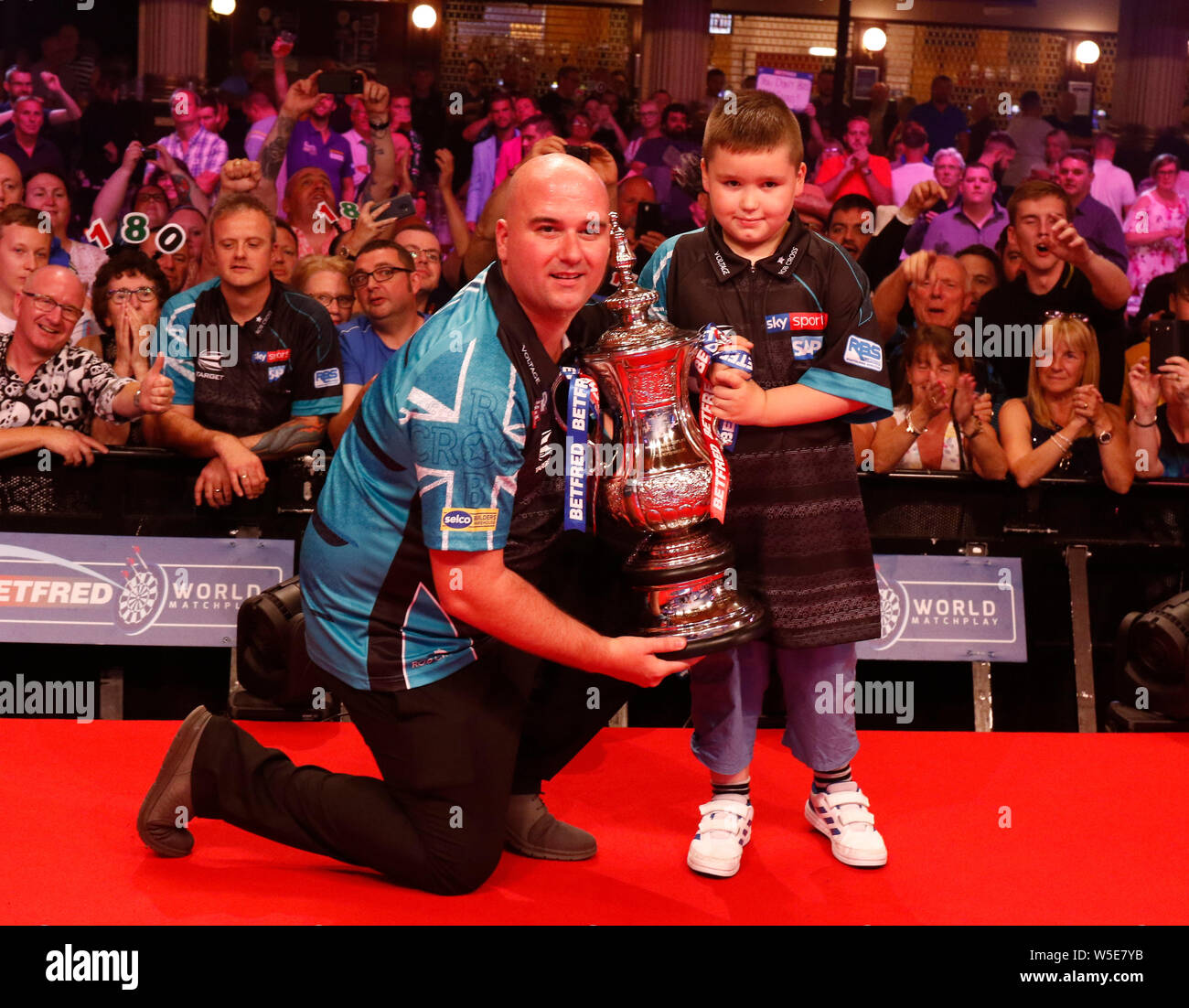 Empress Ballroom Winter Gardens Blackpool. 28th July, 2019. 2019 Betfred World  Matchplay Darts; Final; Rob Cross (ENG) and his son with the World Matchplay  trophy after his victory over Michael Smith (ENG)