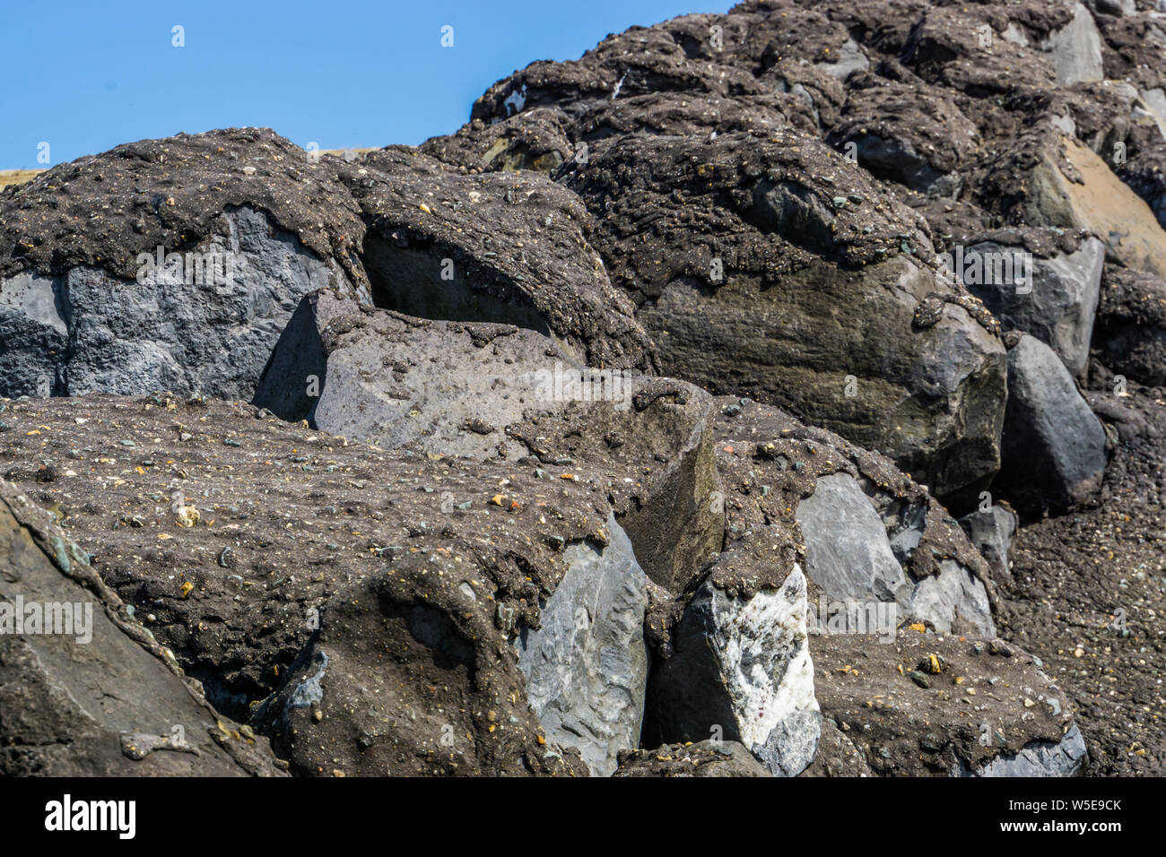 big rocks covered in black tar, Architecture background, Closeup