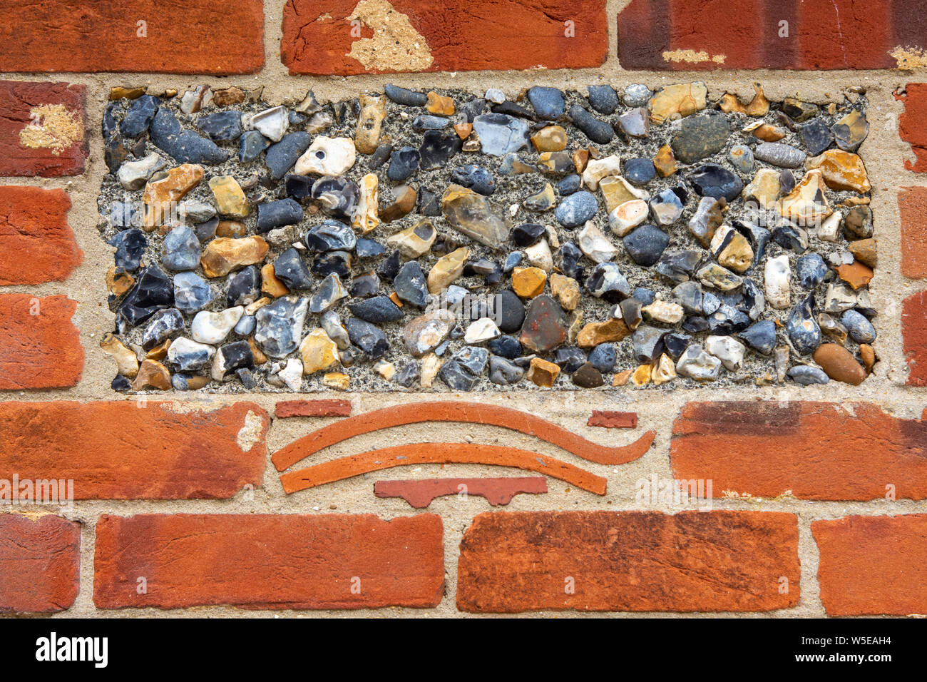 Block of wall made of flint and old roof tiles Stock Photo Alamy