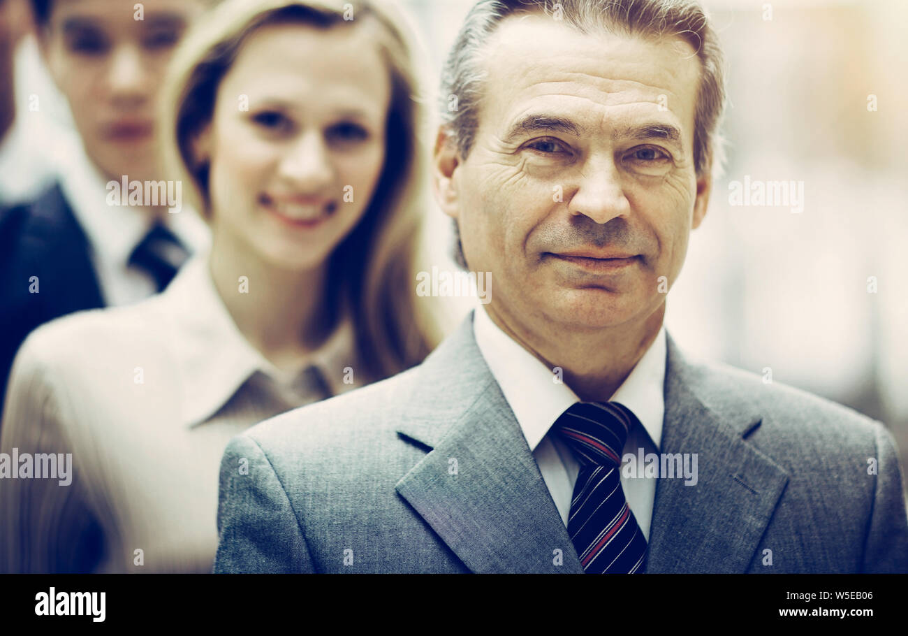 Happy smiling business team standing in a row at office Stock Photo - Alamy