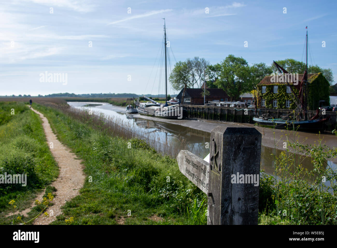 Mudflats and reed beds on River Alde just below Snape Maltings showing the remains of old flood defences which is now a fottpath Stock Photo