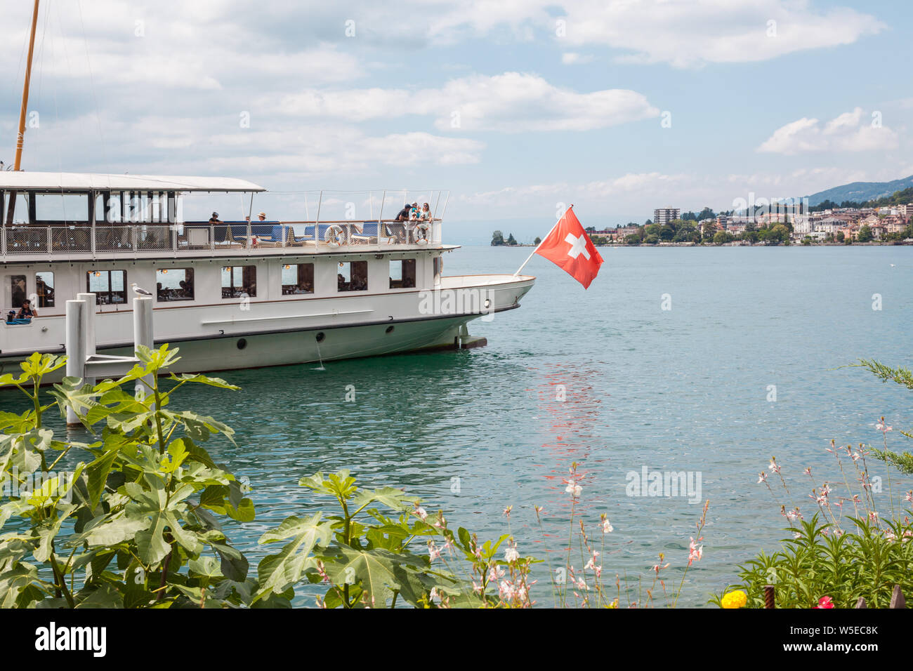 The Belle Epoque retro paddle boat with Swiss flag at the stern moored in Montreux, Lake Geneva (lac Leman), Vaud, Switzerland on sunny summer day Stock Photo
