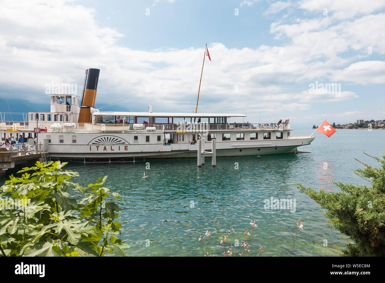 The Belle Epoque retro paddle boat named Italie with Swiss flag at the stern moored in Montreux, Lake Geneva (lac Leman), Vaud, Switzerland Stock Photo