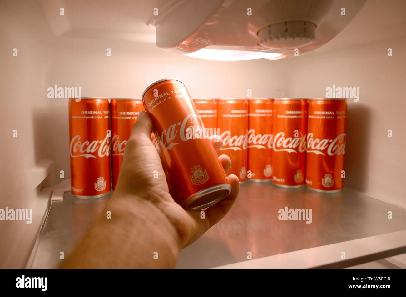 https://c8.alamy.com/comp/W5ECJR/kharkiv-ukraine-july-15-2019-male-hand-shows-coca-cola-red-drink-can-inside-domestic-cooler-fridge-full-of-coke-cans-coca-cola-is-well-known-and-W5ECJR.jpg