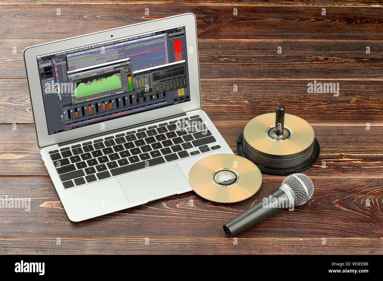Laptop with compact discs and microphone. Stock Photo