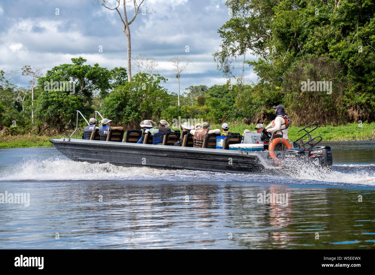 Skiffs from the Zafiro take International Expeditions passengers on daily wildlife safaris on expeditionary river cruises in the Peruvian Amazon Stock Photo