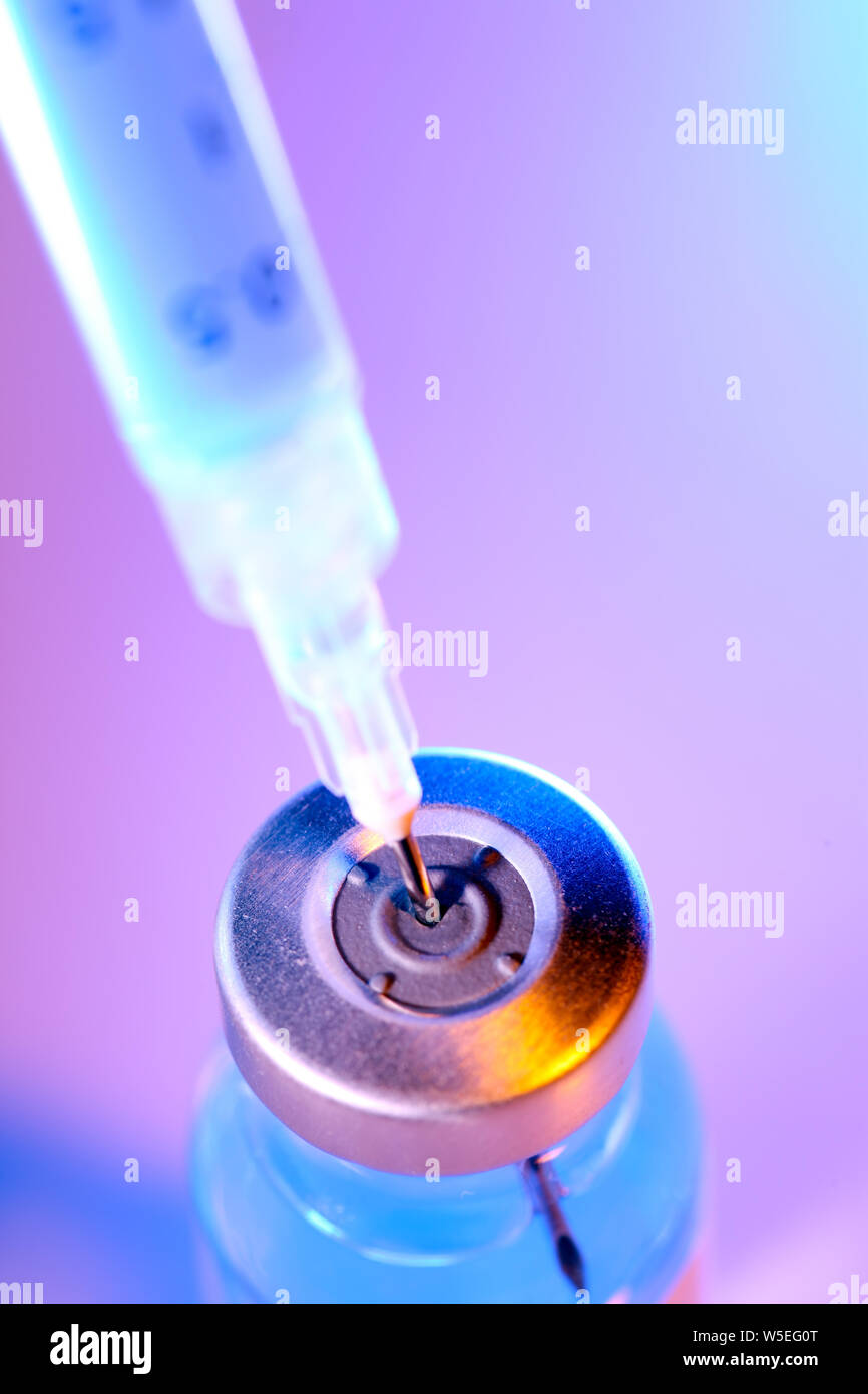 Drug vial with syringe background Stock Photo