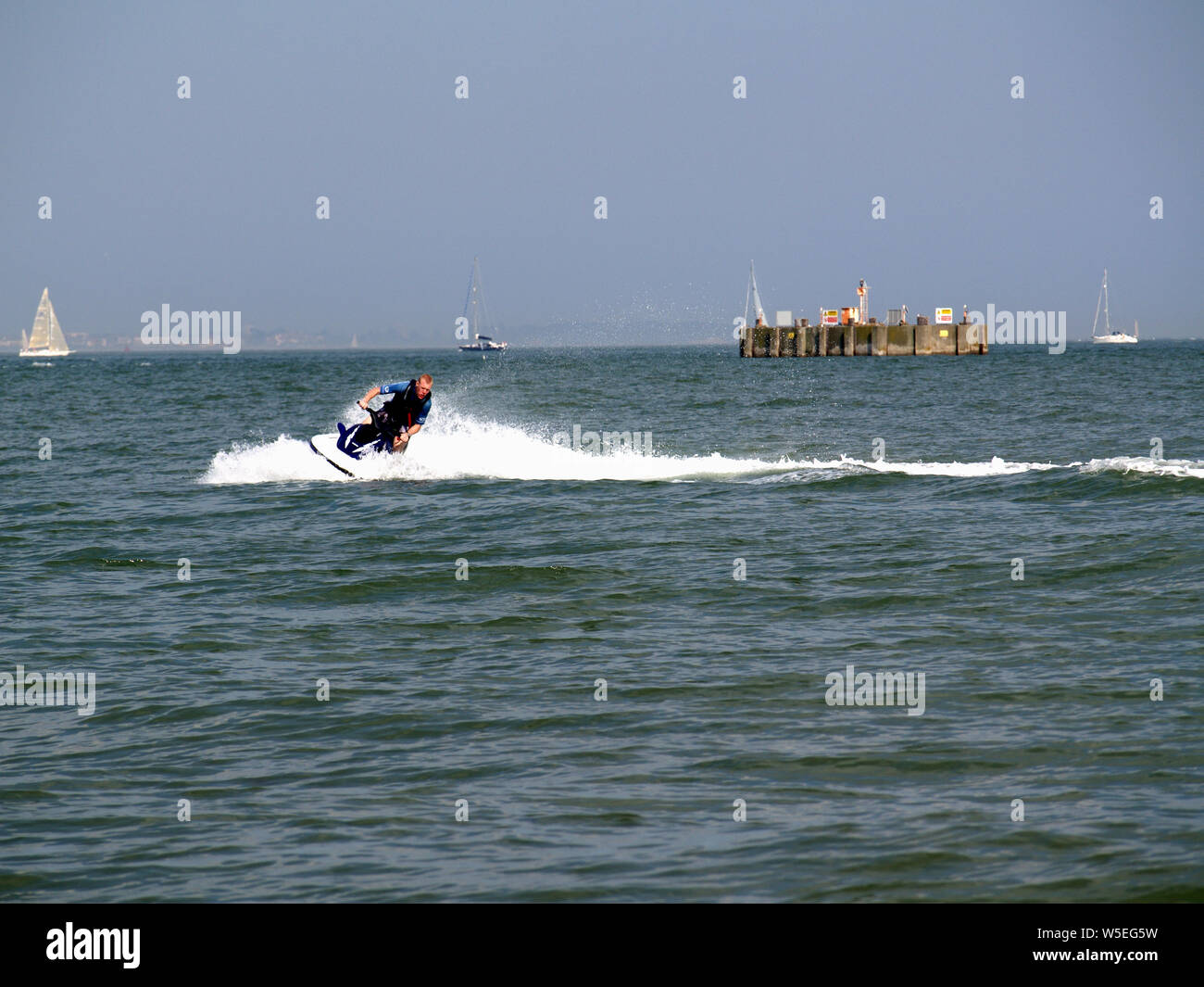 Man riding jet ski at Calshot Activities Centre, Hampshire, England UK