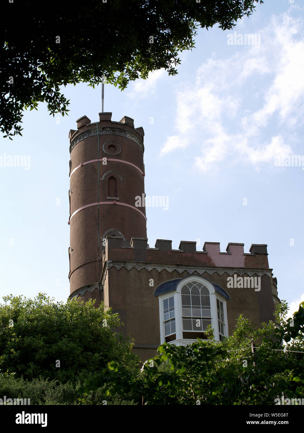 Luttrell's Tower, a 3 story stuccoed yellow brick folly at Calshot