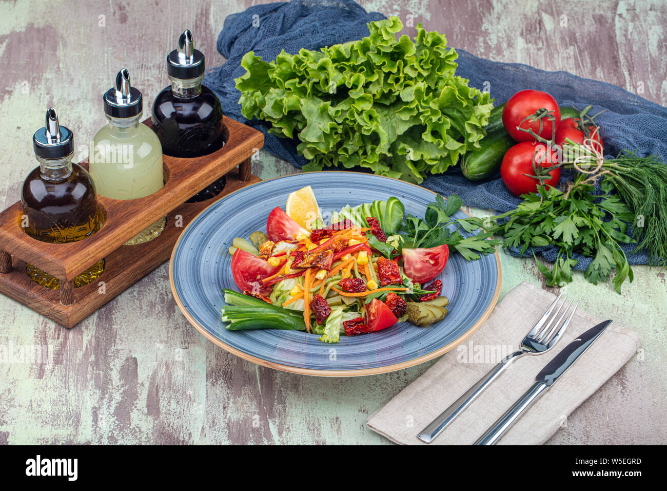 Seasonal salad with sun dried tomatoes (lettuce, cucumber, corn, carrot