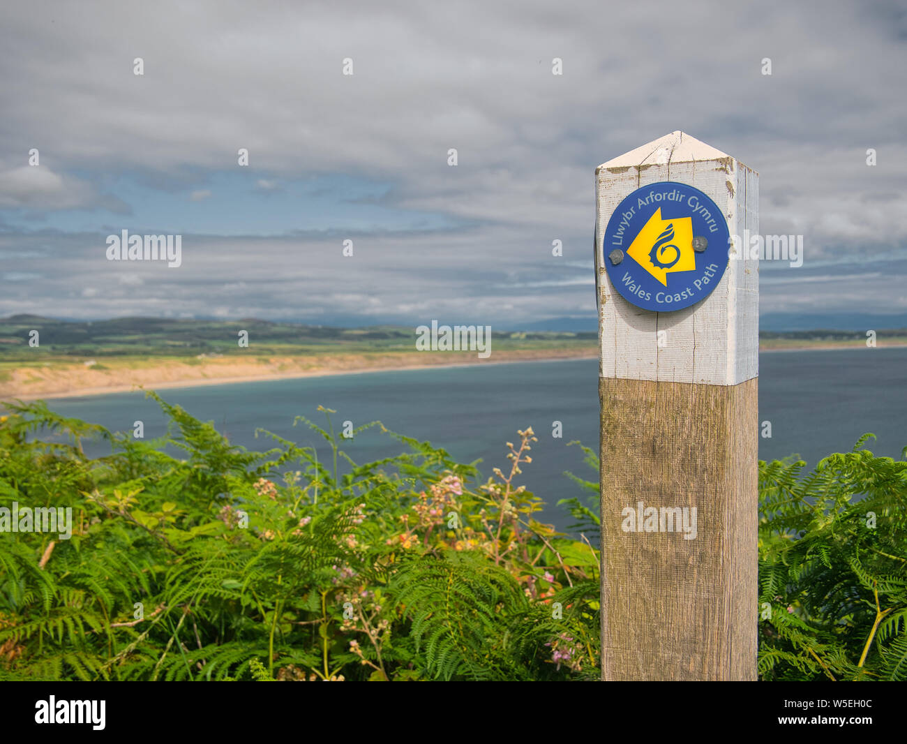 Wooden sign post on the Wales Coast Path on the Llyn Peninsula, Gwynedd, Wales, UK Stock Photo