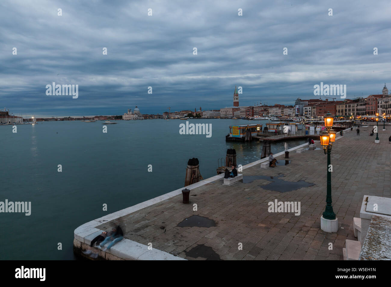 Venice in the blue hour,beautiful dusk in Venice with ships,gondolas and tourists enjoying the atmosphere. Stock Photo