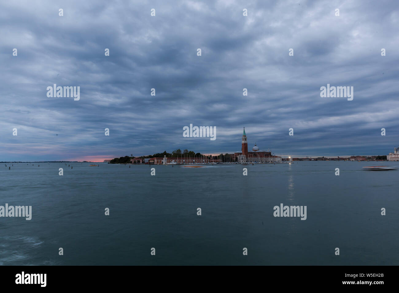 Venice in the blue hour,beautiful dusk in Venice with ships,gondolas and tourists enjoying the atmosphere. Stock Photo