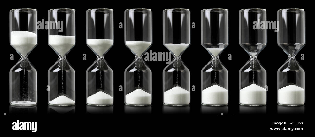 Collection of hourglasses with white sand showing the passage of time ...