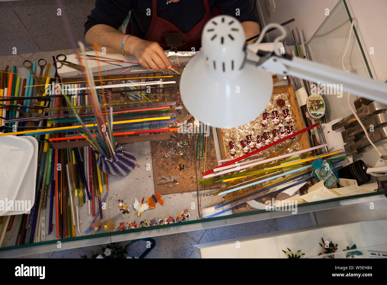 A skilled crafts woman on the Island of Muranoin Venice , making pieces made from the famous Murano Glass. Stock Photo