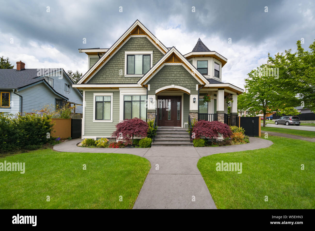Residential family house with concrete pathway over front yard Stock Photo