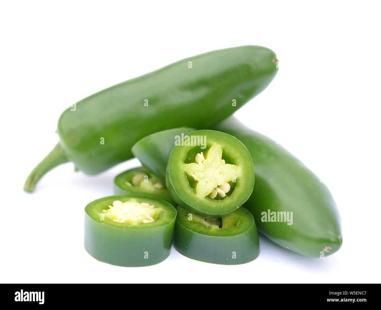chopped and whole jalapenos peppers on white Stock Photo