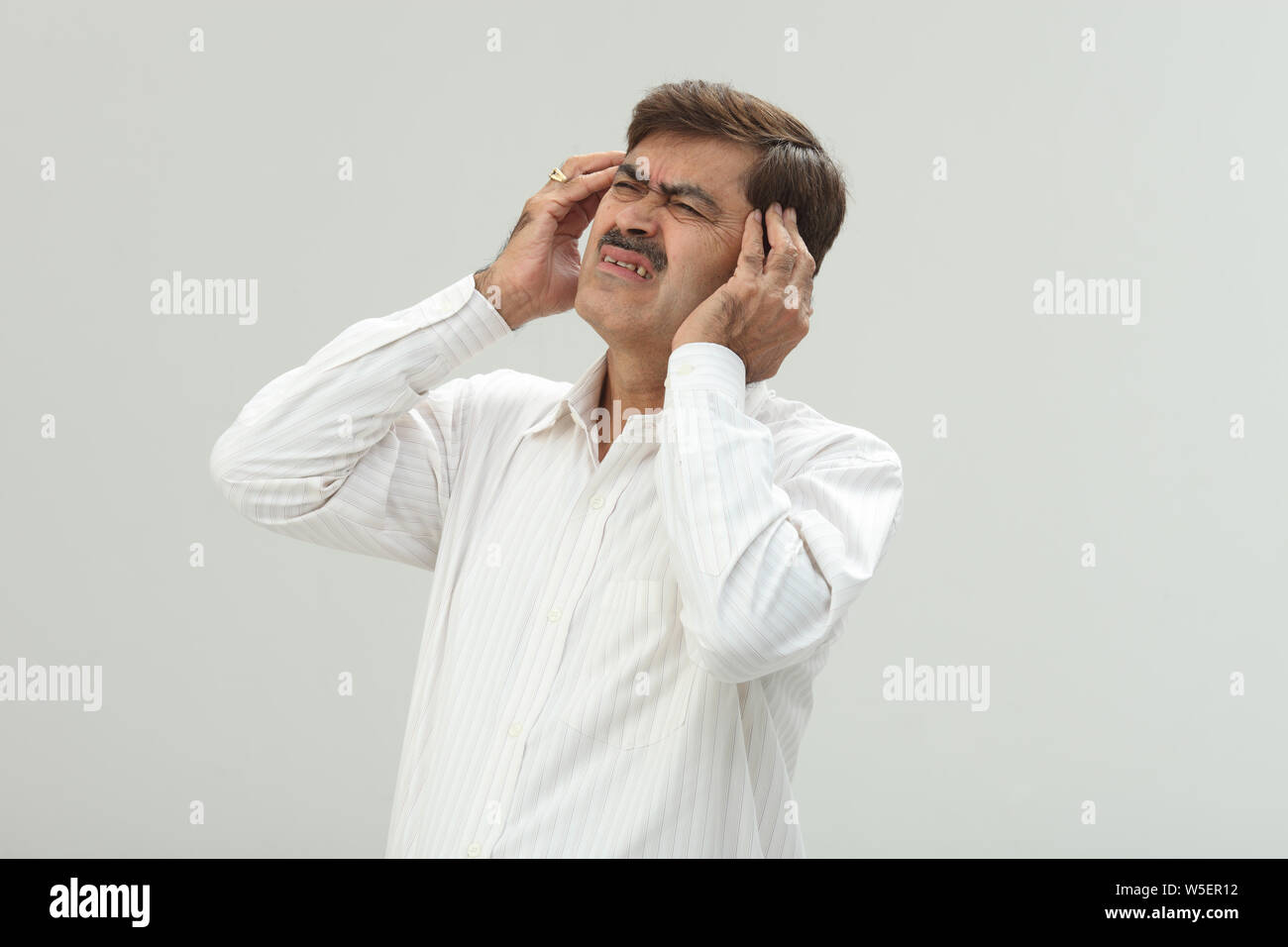 Indian businessman suffering from headache Stock Photo - Alamy