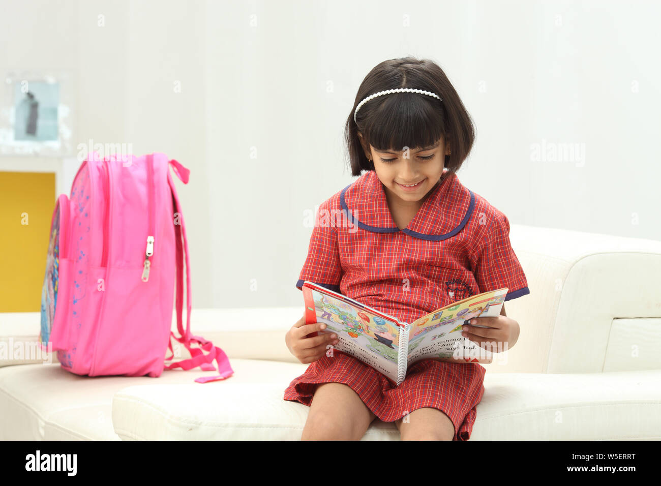 Schoolgirl reading a book Stock Photo - Alamy
