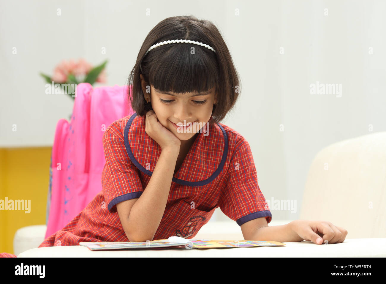 Schoolgirl reading a book Stock Photo - Alamy
