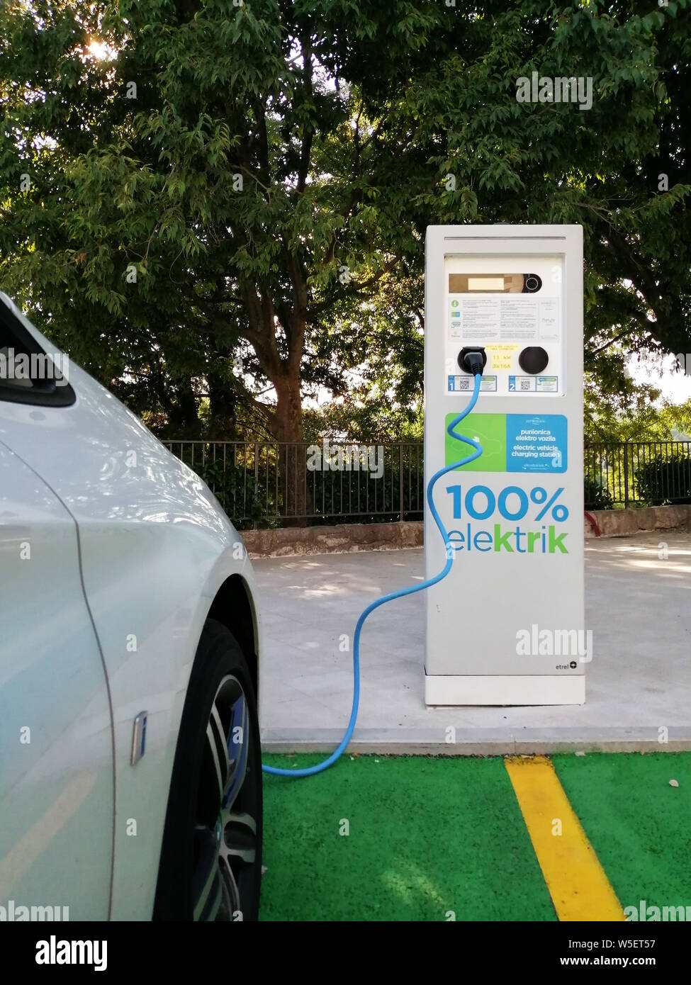Electric car charging at a charging station Stock Photo