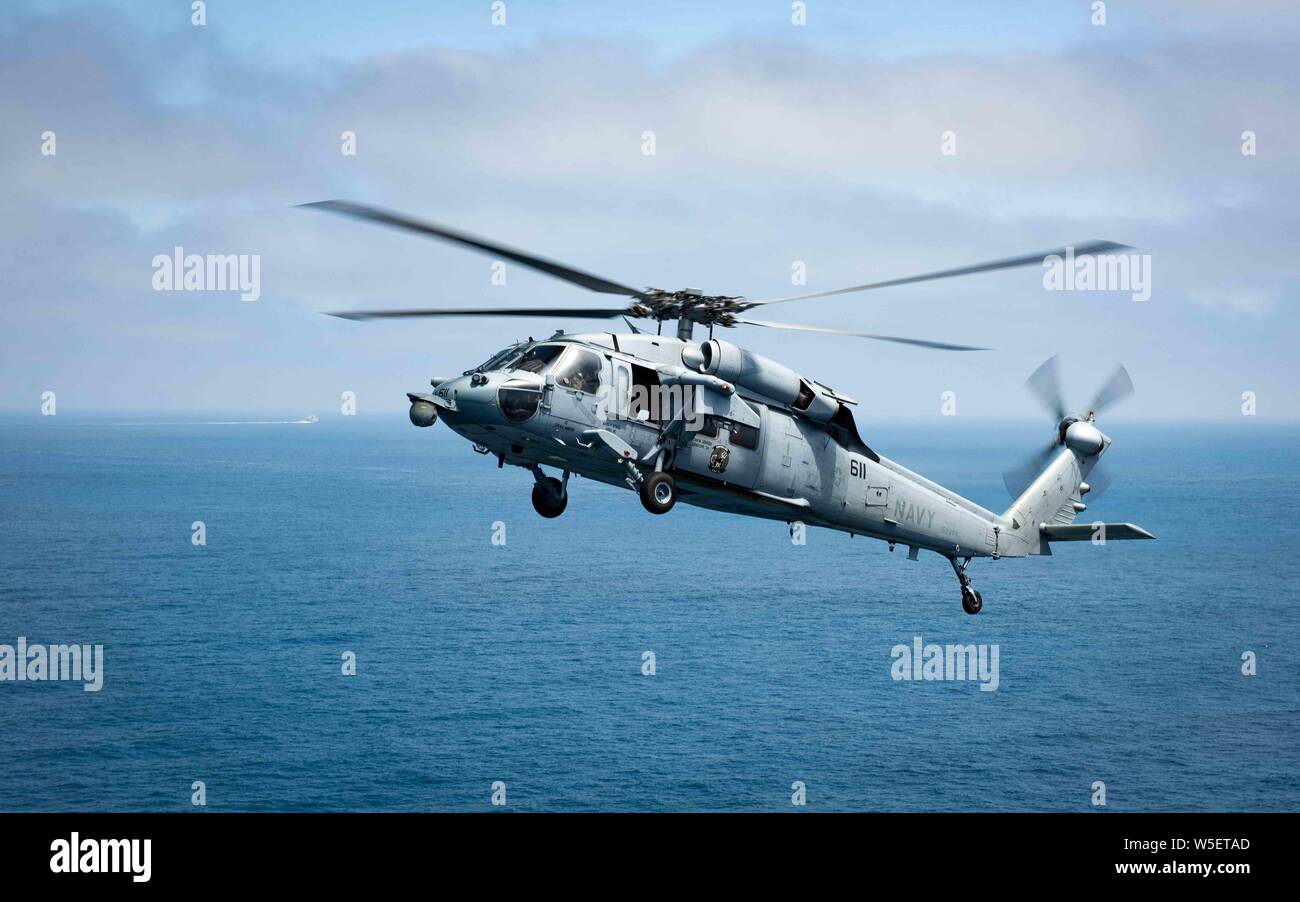 190726-N-XC372-1685 PACIFIC OCEAN (July 26, 2019) An MH-60S Sea Hawk, assigned to the “Eightballers” of Helicopter Sea Combat Squadron (HSC) 8, hovers over the Pacific Ocean. HSC-8 is conducting routine operations in the Eastern Pacific Ocean. (U.S. Navy photo by Mass Communication Specialist 2nd Class Anthony J. Rivera/Released) Stock Photo