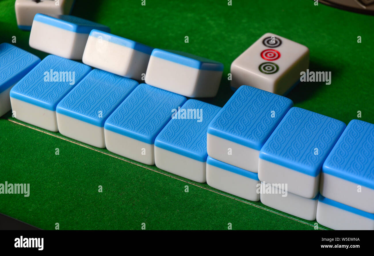 Mahjong game on green table at rural house in Nanning, China. Stock Photo