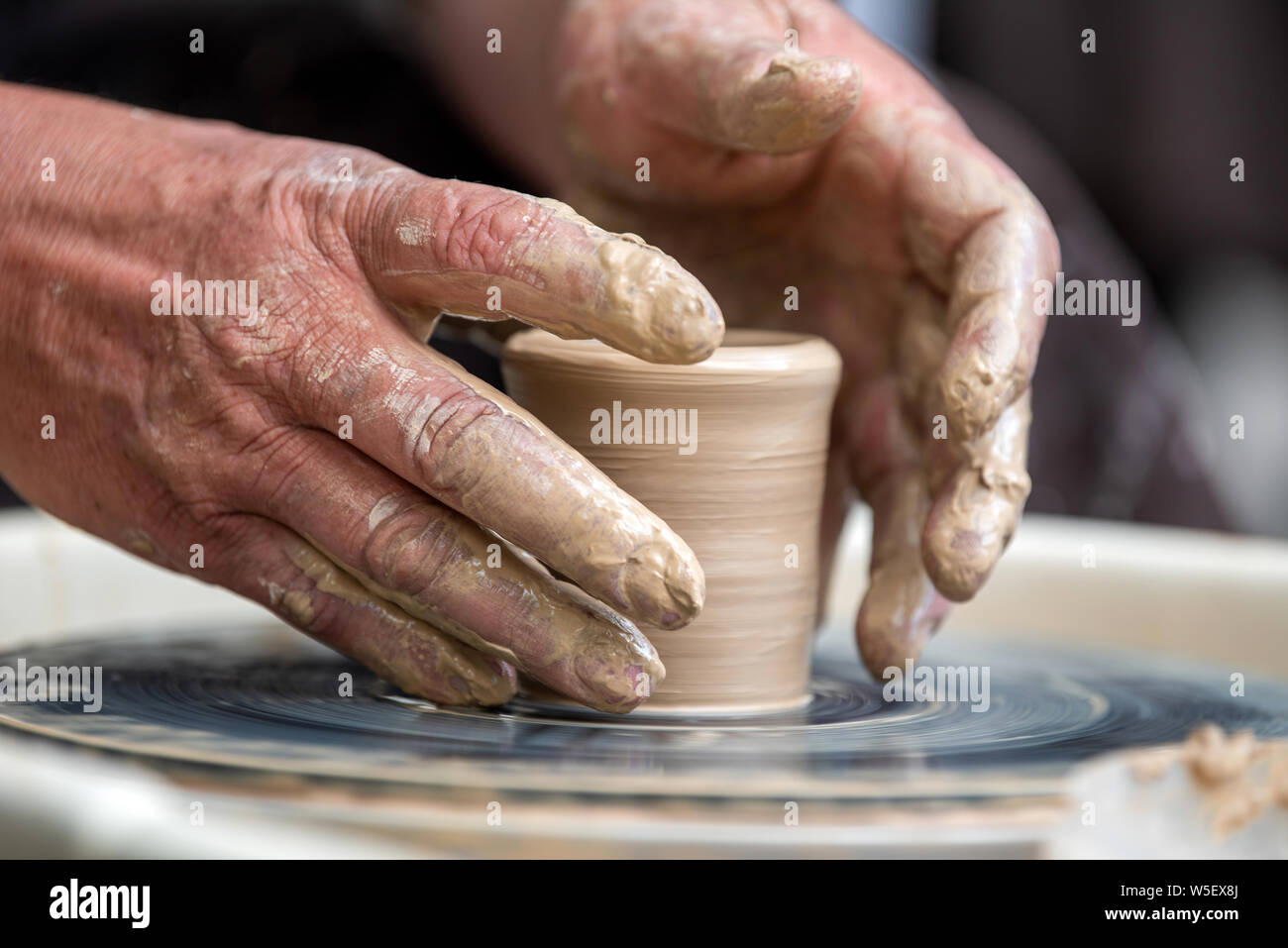 Hands working on pottery wheel. Sculptor, Potter. Human Hands