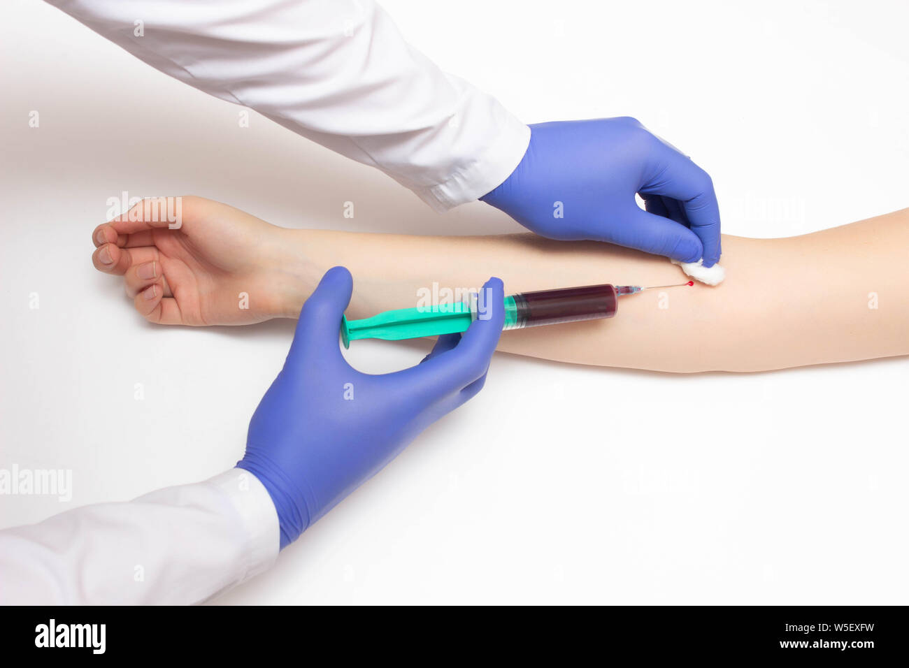 Doctor takes blood from a girl's vein for immunoglobulins and hepatitis, reaction to allergens, copy space, immunogram, method of elisa, immune system Stock Photo
