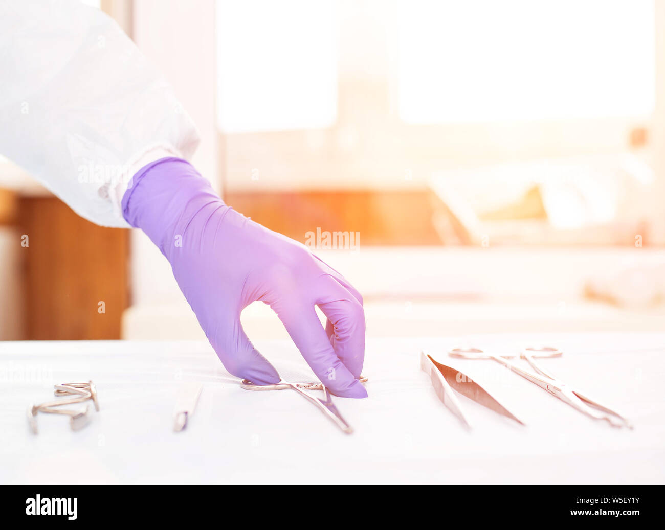 Doctor takes medical instruments from the table for the concept of ...