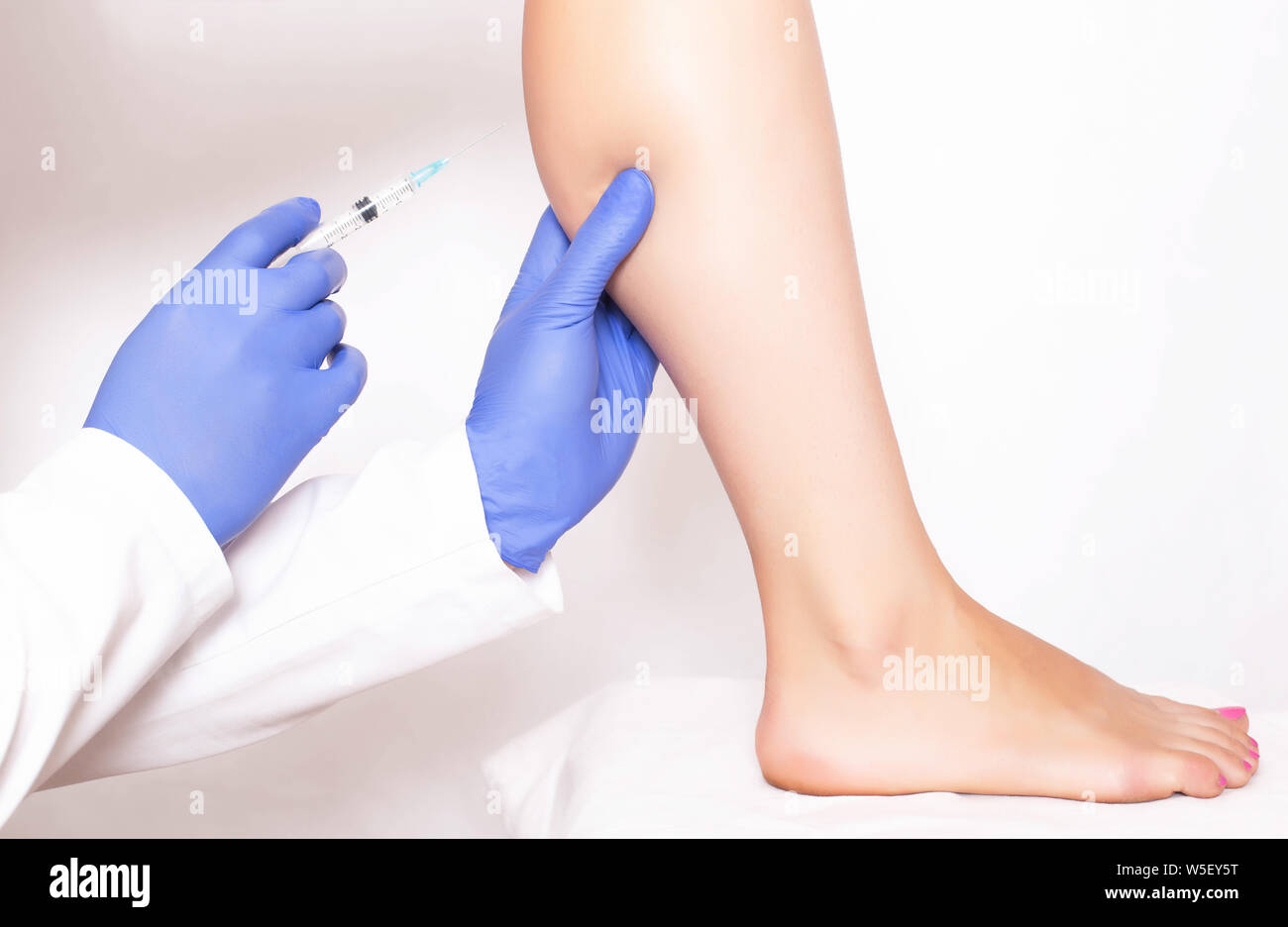 Doctor cosmetologist makes rejuvenation beauty injection to the calf