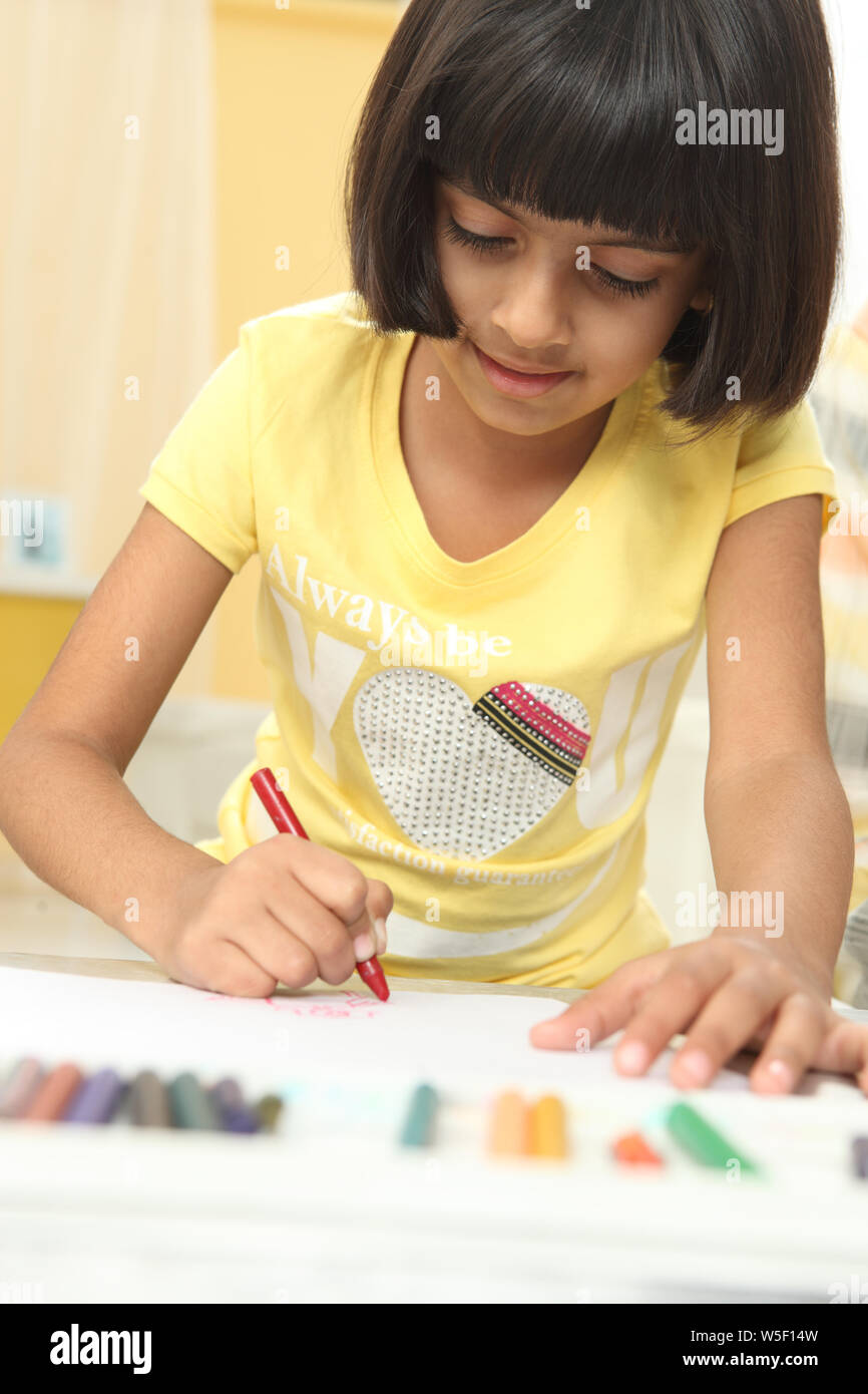 Girl coloring a book at home Stock Photo - Alamy