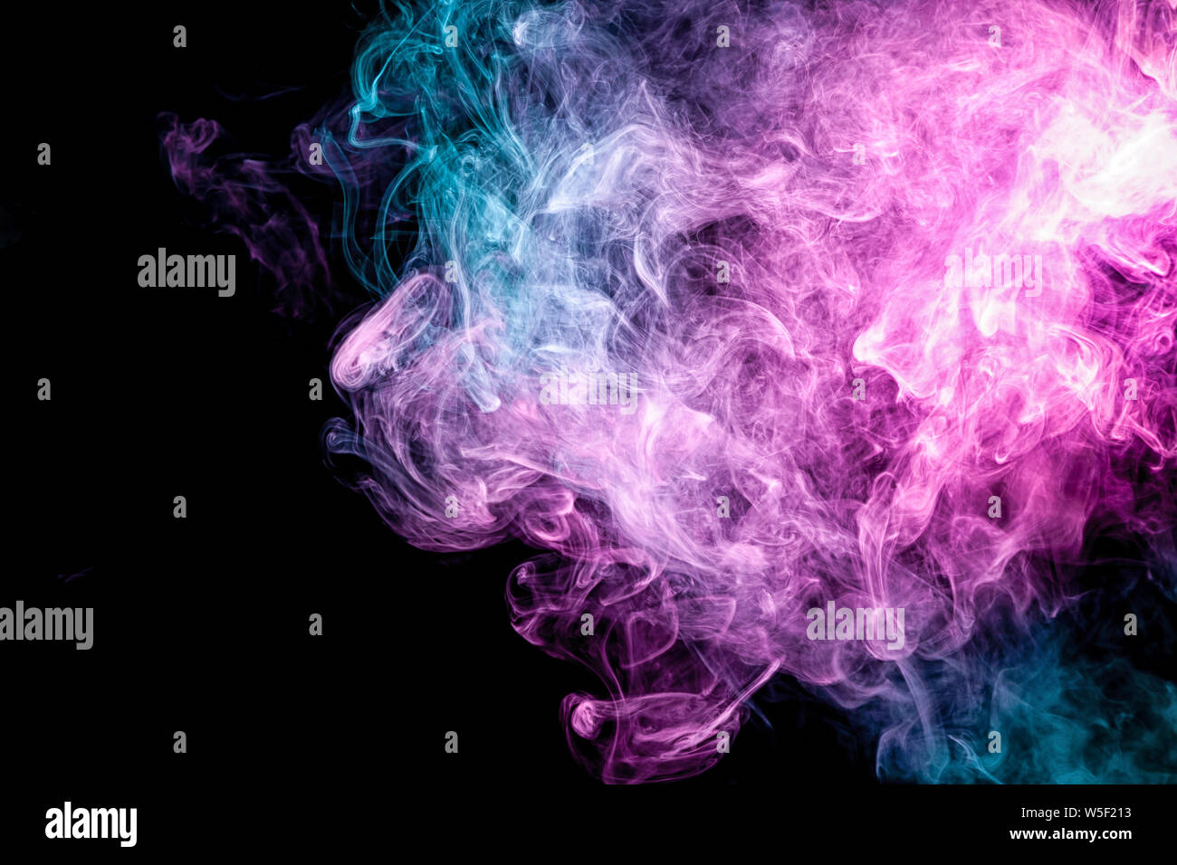 Fog colored with bright pink and blue gel on dark background. Colorful  cloud smoke on black isolated background Stock Photo - Alamy