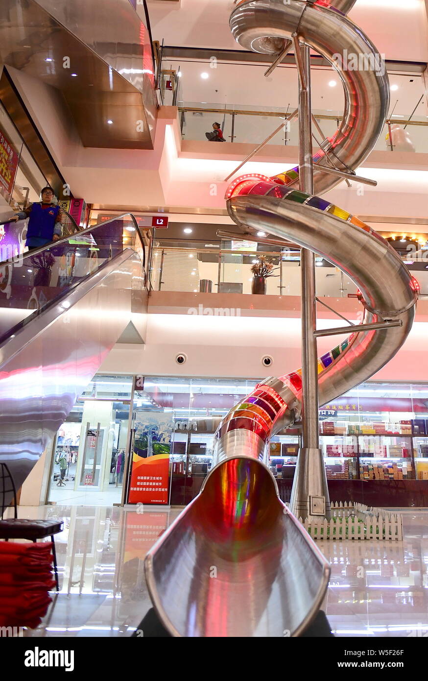 A customer tries out the 20-meter tall super slide at a shopping mall in  Shenyang city, northeast China's Liaoning province, 5 March 2019. A shoppin  Stock Photo - Alamy