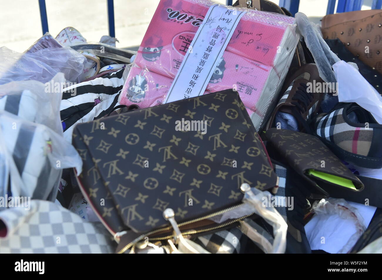 The counterfeits of luxury bags are to be smashed on the World Consumer Rights Day, often referred to as '315' in China, in Tianjin, China, 15 March 2 Stock Photo