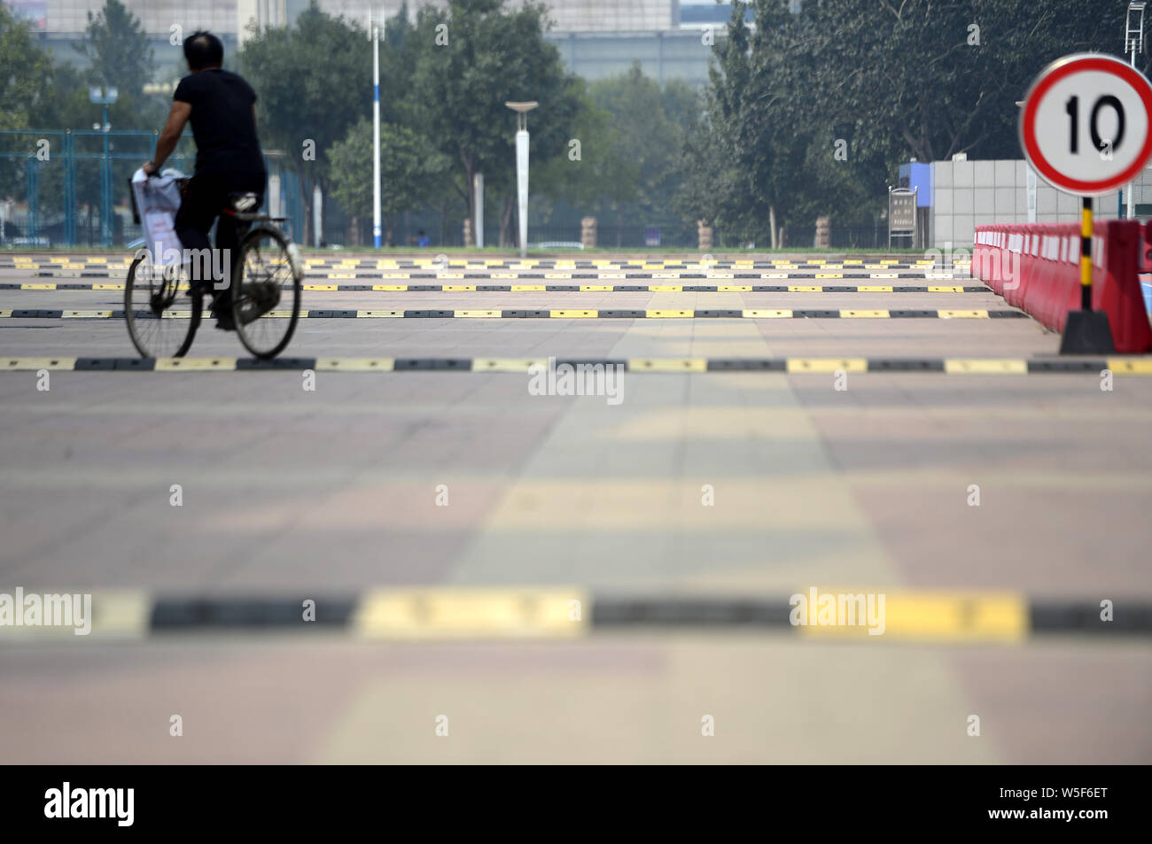 FILECustomers walk past a "washboard road" with dense speed bumps