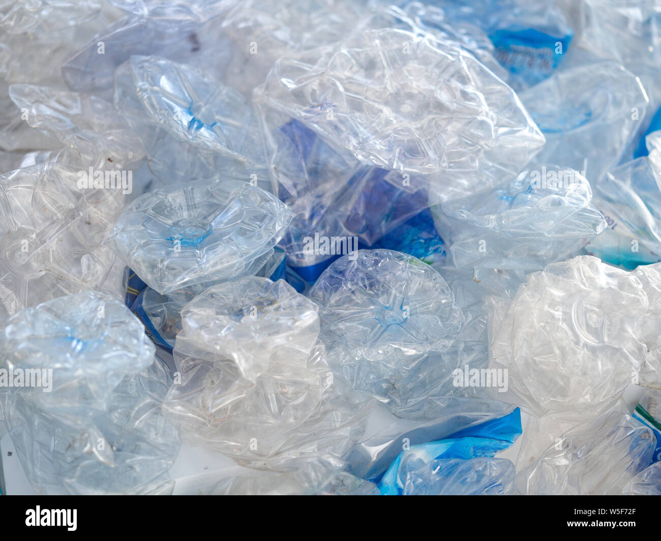 Water plastic bottles crushed and crumpled against background, Recycle