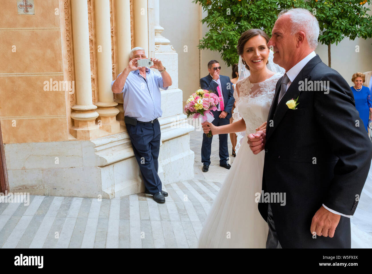 arrival of the bride and her father for a wedding Church of San Juan Bautista in Malaga, Andalousie Spain Stock Photo